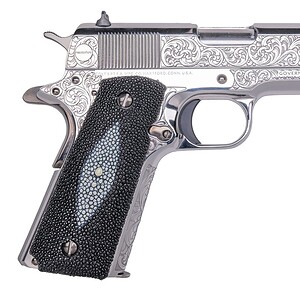 Engraved silver pistol with intricate floral patterns and black grip.