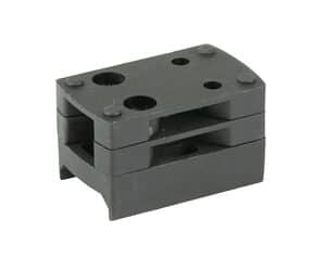 Brass block with multiple drilled holes for machining and industrial applications.