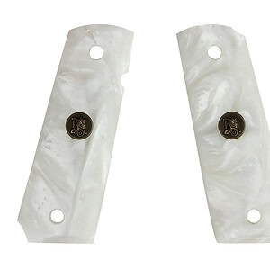 Mother of pearl grips with brass emblem for musical instruments.
