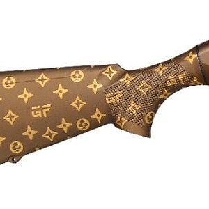 Custom Louis Vuitton patterned rifle with brown finish and long barrel.