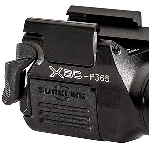 Tactical flashlight with laser sight for firearms, black gun accessory.